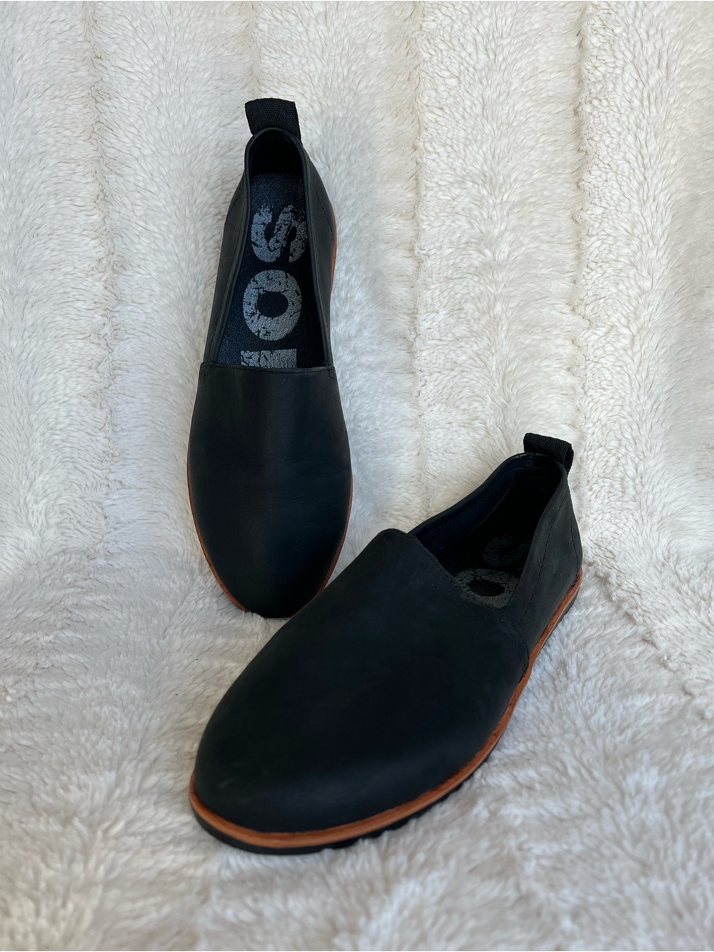 Sorel women’s Black Slip-On Leather flats with Brown Trim